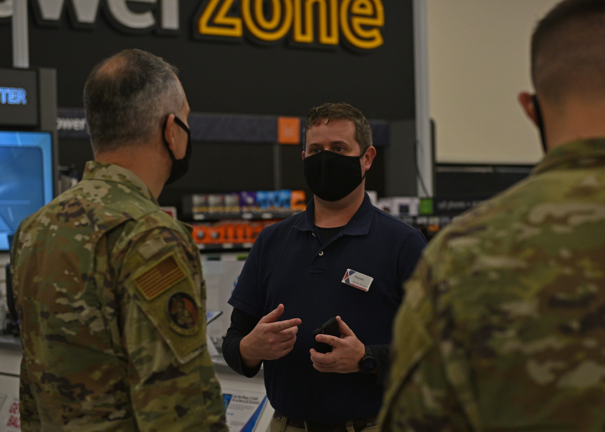 Patrick Siler, Goodfellow Air Force Base Exchange wireless advocates manager, assists customers during the grand opening of the Exchange on Goodfellow AFB, Texas, Aug. 5, 2021. The newly renovated Exchange was a $9.3 million project started in September 2019.  (U.S. Air Force photo by Senior Airman Ashley Thrash)