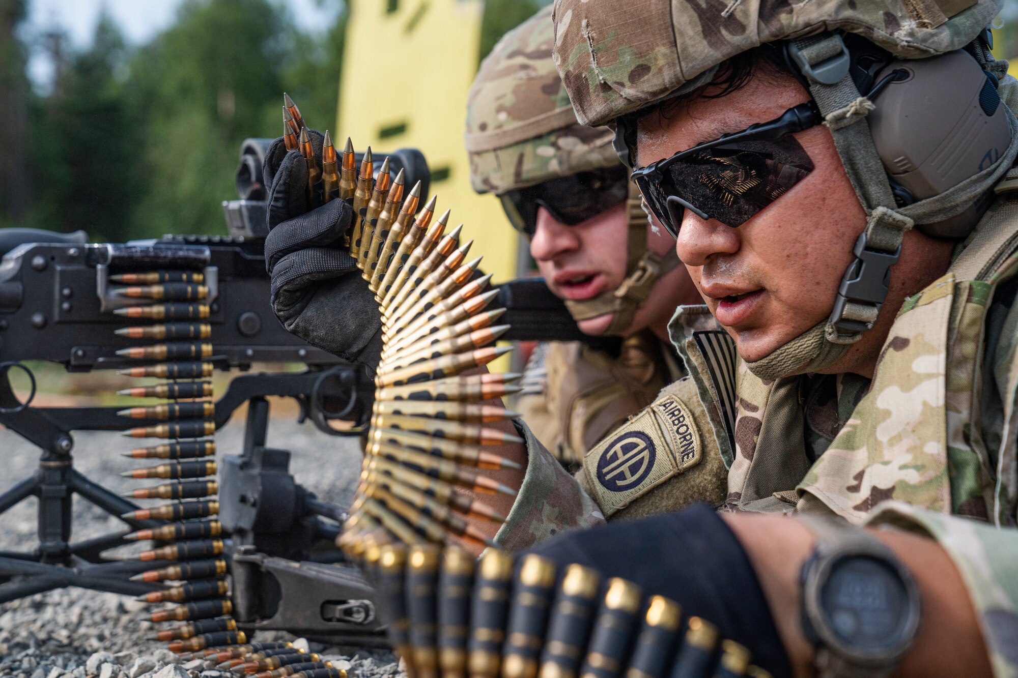 U.S. Army Sgt. Ramon Villalobos (left) and Spc. Paxton Butler, combat engineers assigned to the 6th Brigade Engineer Battalion (Airborne), 4th Infantry Brigade Combat Team (Airborne), 25th Infantry Division, U.S. Army Alaska, prepare to fire an M240B machine gun while conducting live-fire training.