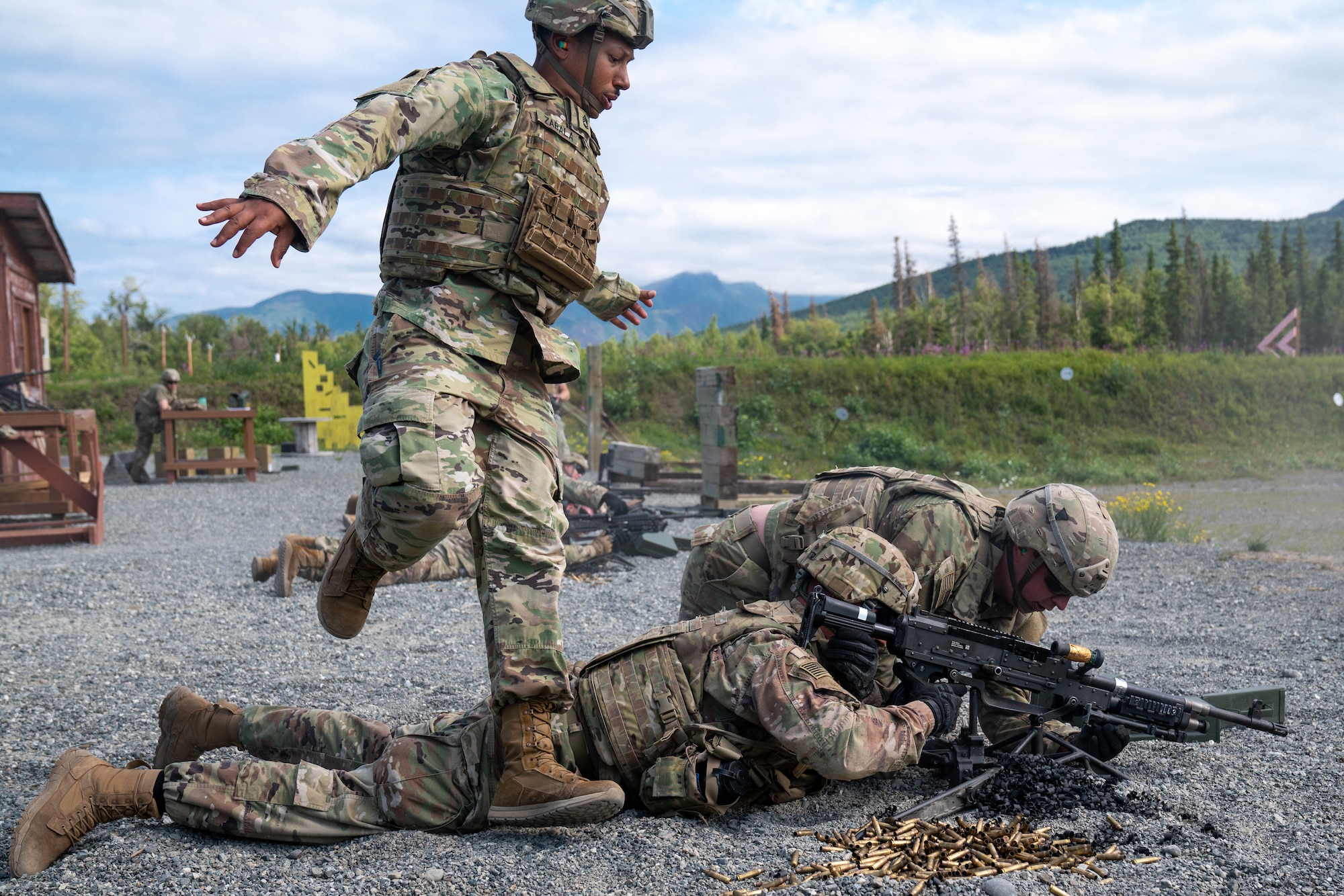 U.S. Army Sgt. 1st Class Kelvin Zabala, Spc. Trevor Tate, and Pvt. Charles Becker, combat engineers assigned to the 6th Brigade Engineer Battalion (Airborne), 4th Infantry Brigade Combat Team (Airborne), 25th Infantry Division, U.S. Army Alaska, troubleshoot a malfunctioning M240B machine gun while conducting live-fire training.