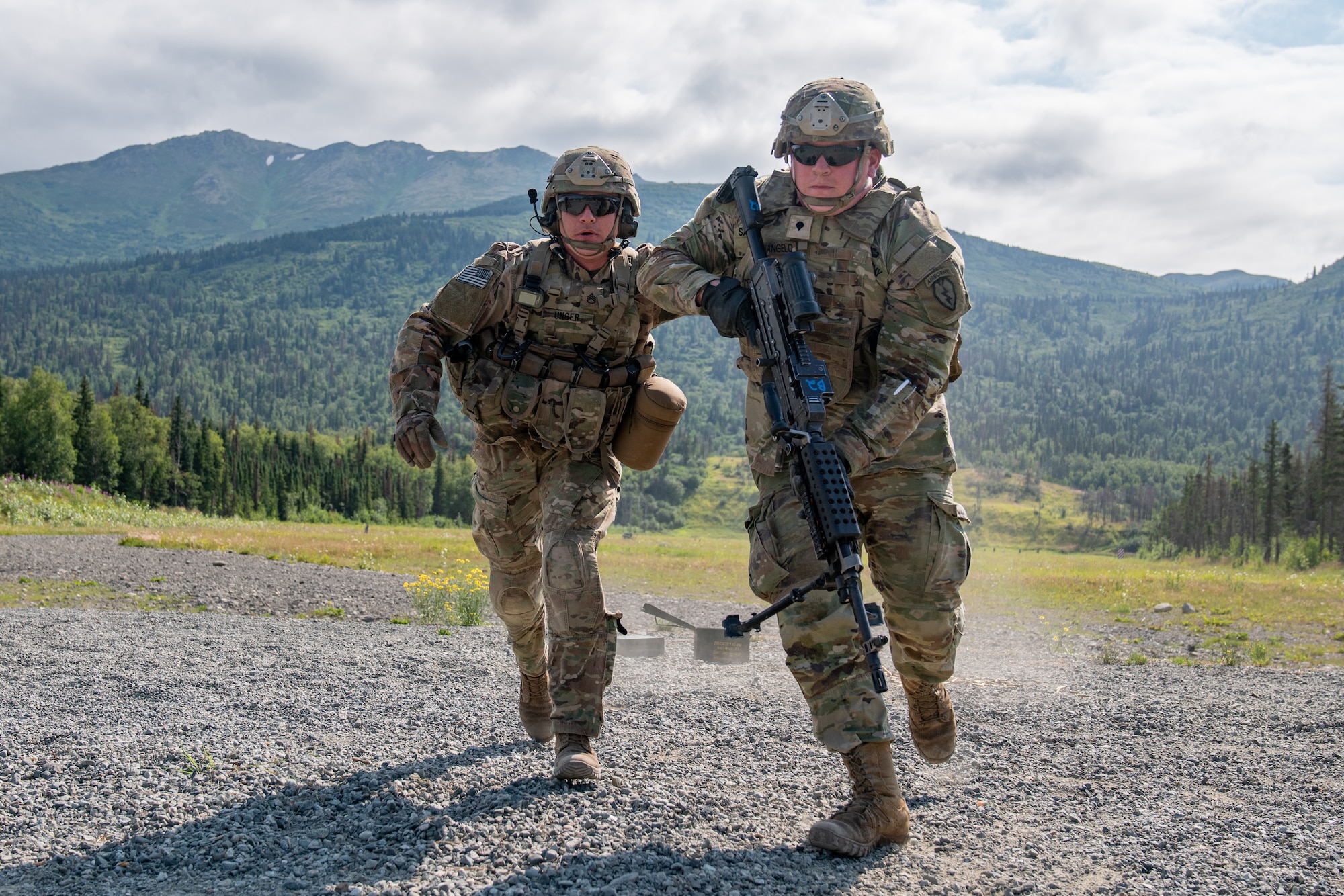 U.S. Army Sgt. Jacob Unger and Spc. James Sanangelo, combat engineers assigned to the 6th Brigade Engineer Battalion (Airborne), 4th Infantry Brigade Combat Team (Airborne), 25th Infantry Division, U.S. Army Alaska, retreat from their firing position while conducting live-fire training.