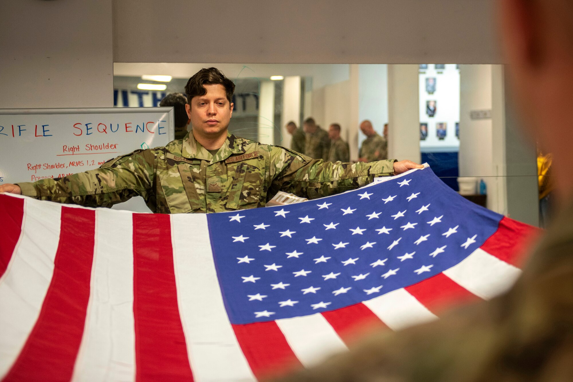 U.S. Air Force Airman 1st Class Richard Rosario, a Joint Base Elmendorf-Richardson Honor Guardsman, demonstrates a ceremonial folding of the flag during an Honor Guard Open House at JBER, Alaska, July 19, 2021. The Honor Guard hosted the event to encourage Airmen to participate in the Honor Guard program. (U.S. Air Force photo by Senior Airman Emily Farnsworth)