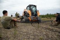 A 211th General Support Aviation Battalion CH-47 Chinook helicopter transports a skid-steer loader by slingload from Nicolai to the community of Telida, Alaska, as part of the Innovative Readiness Training program on July 27, 2021. The IRT program is designed to enhance mission readiness while addressing the needs within America's communities. (U.S. Army National Guard photo by Victoria Granado)