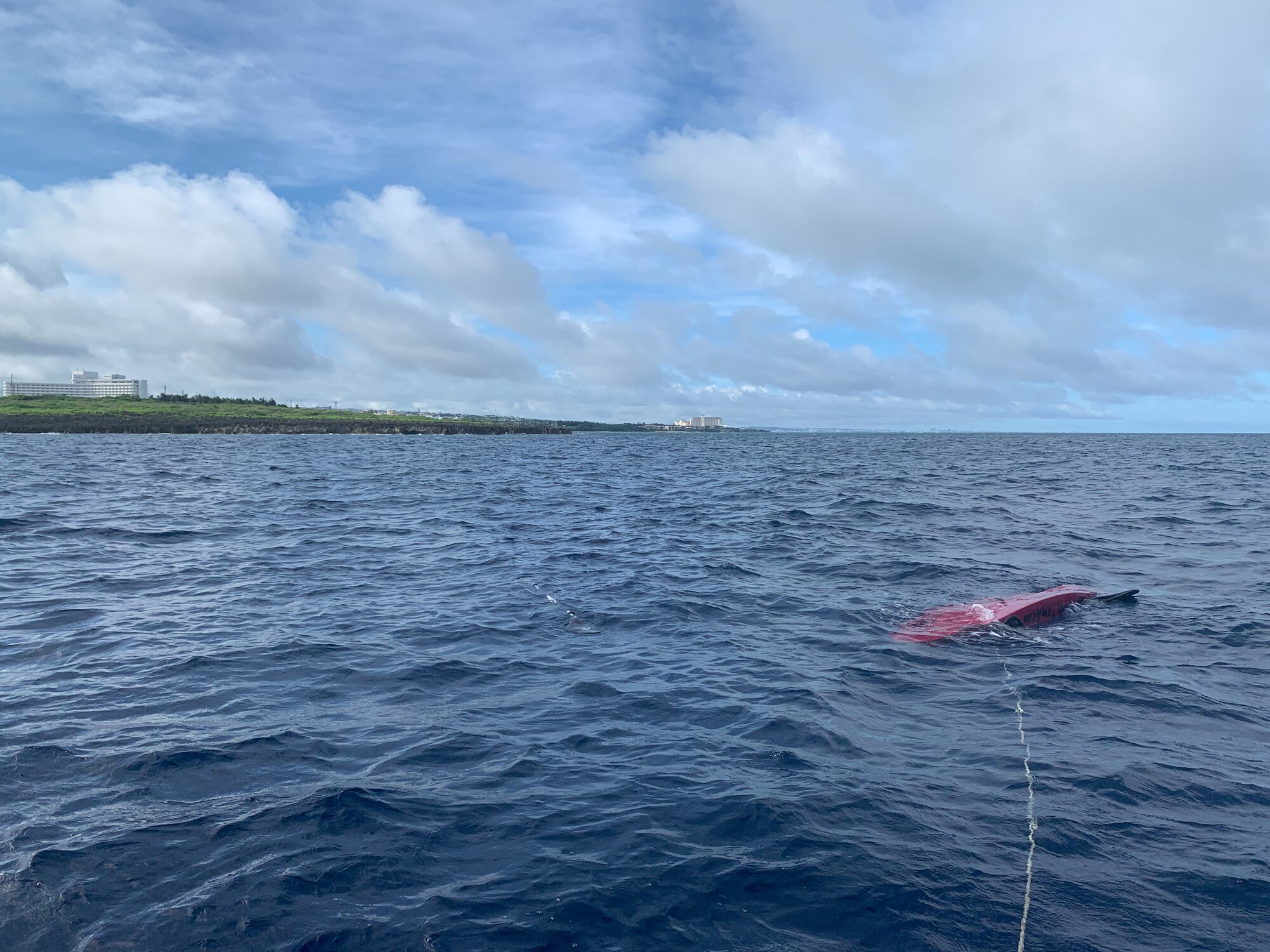 A kayak attached to a rope is flipped over in the water half a mile off the coast of Cape Zanpa, Okinawa, June 13, 2021.