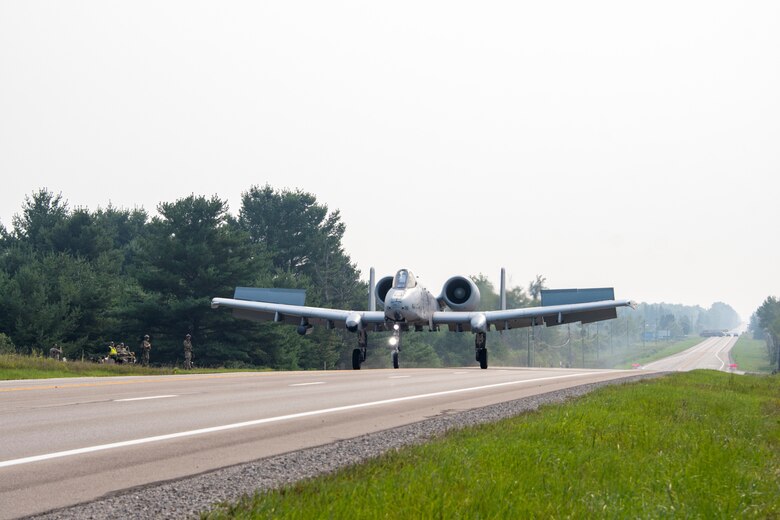 A photo of an A-10 landing on a highway