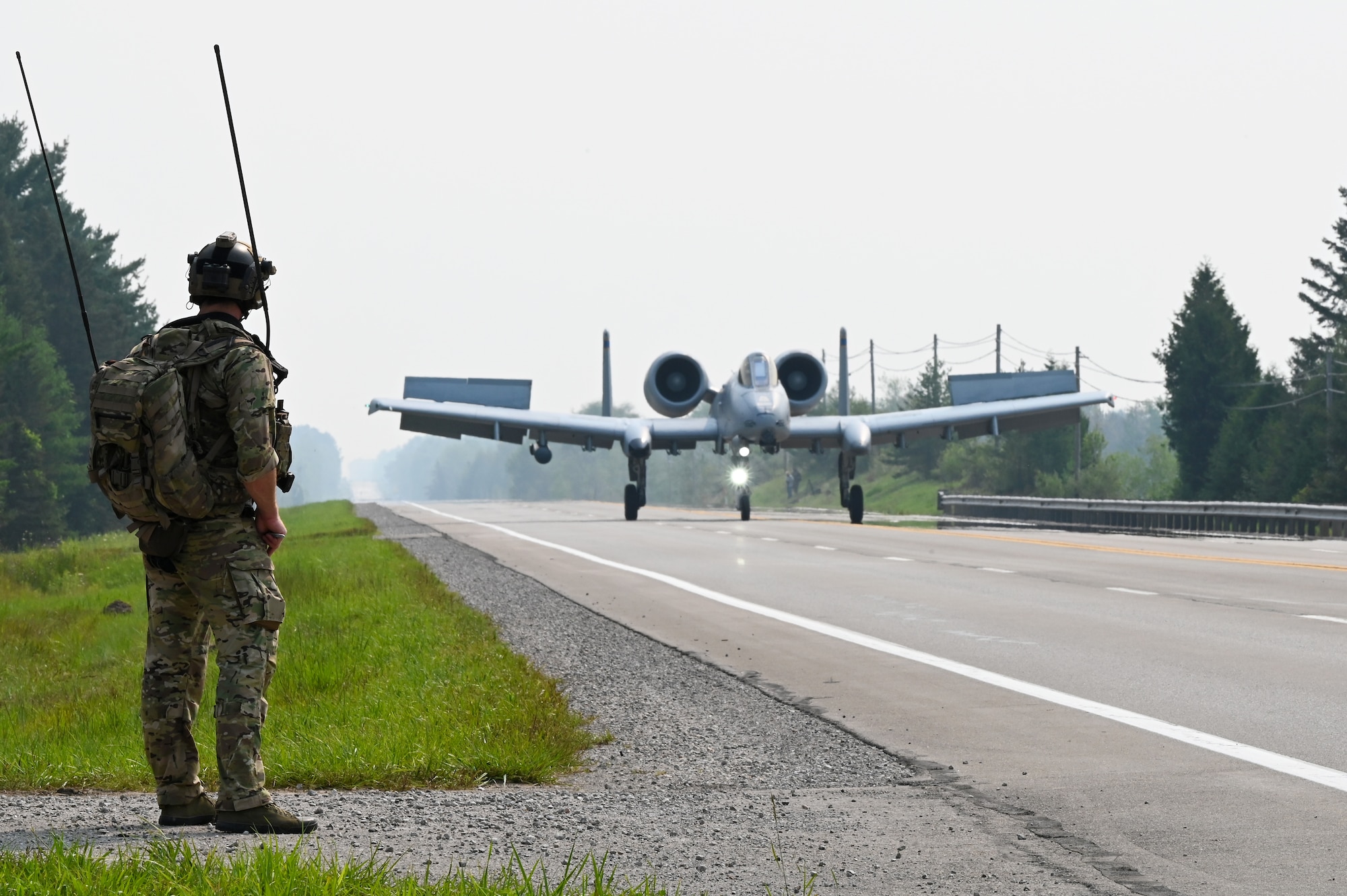 A U.S. Air Force 127th Wing A-10 Thunderbolt II, with ground air traffic control and guidance provided by Special Tactics operators from the 24th Special Operations Wing, lands on a closed public highway Aug. 5, 2021 at Alpena, Mich., for the first time ever as part of a training exercise during Northern Strike 21. The joint training event tested part of the agile employment concept, focusing on projecting combat power from austere locations. (U.S. Air Force photo by Staff Sgt. Ridge Shan)