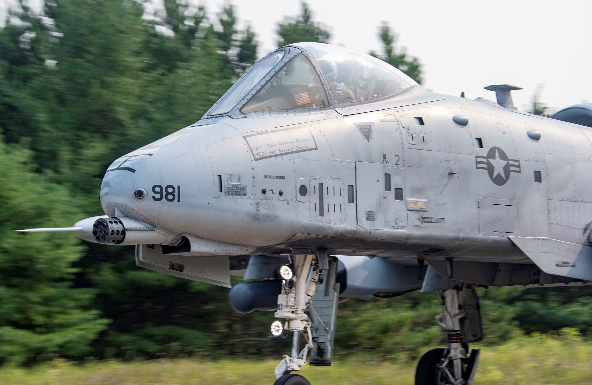 A photo of an A-10 landing on a highway