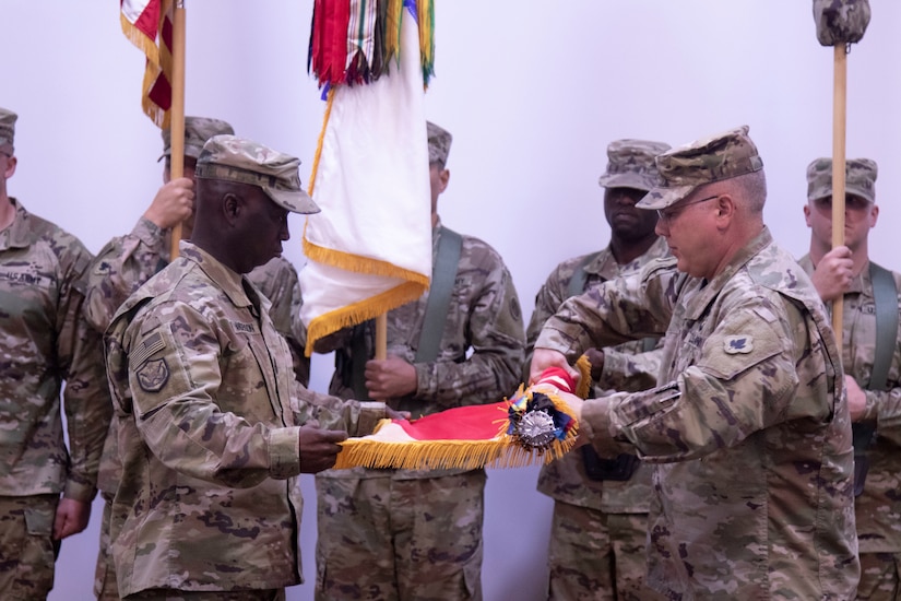 Col. Thomas Dennis and Command Sgt. Maj. Orlando Anderson case the 143rd Regional Support Group colors during a Transition of Authority ceremony. The 143rd transition command of Area Support Group Jordan to Col. Toni Sabo and Command Sgt. Maj. Jose Hernandez, the previous Area Support Group Qatar command team.