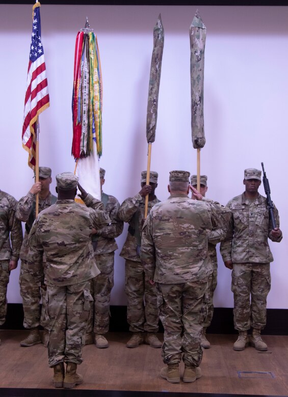 Col. Thomas Dennis and Command Sgt. Maj. Orlando Anderson case the 143rd Regional Support Group colors during a Transition of Authority ceremony. The 143rd transition command of Area Support Group Jordan to Col. Toni Sabo and Command Sgt. Maj. Jose Hernandez, the previous Area Support Group Qatar command team.