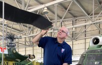 Cliff Barnes, a U.S. Army Aviation and Missile Command Logistics Assistance Representative assigned to the 405th Army Field Support Brigade, inspects a damaged rotor blade on a UH-60 Black Hawk in a hangar at Bucharest International Airport. After the precautionary landing due to a major mechanical problem, Barnes inspected the aircraft with the pilots and mechanics. They looked at all the parts, and Barnes pinpointed what needed to be replaced. (U.S. Army courtesy photo)