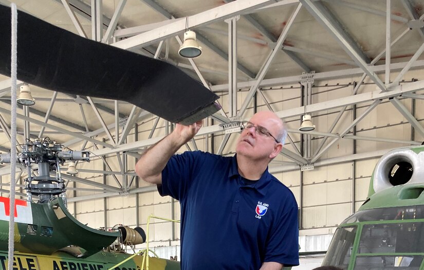 Cliff Barnes, a U.S. Army Aviation and Missile Command Logistics Assistance Representative assigned to the 405th Army Field Support Brigade, inspects a damaged rotor blade on a UH-60 Black Hawk in a hangar at Bucharest International Airport. After the precautionary landing due to a major mechanical problem, Barnes inspected the aircraft with the pilots and mechanics. They looked at all the parts, and Barnes pinpointed what needed to be replaced. (U.S. Army courtesy photo)