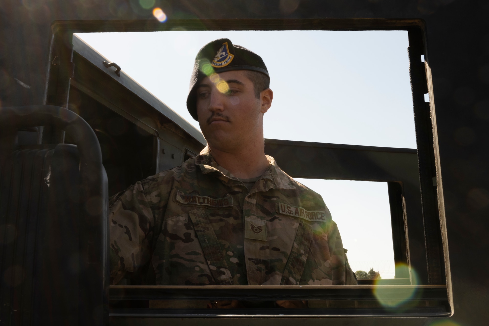 Military instructor inspecting a vehicle