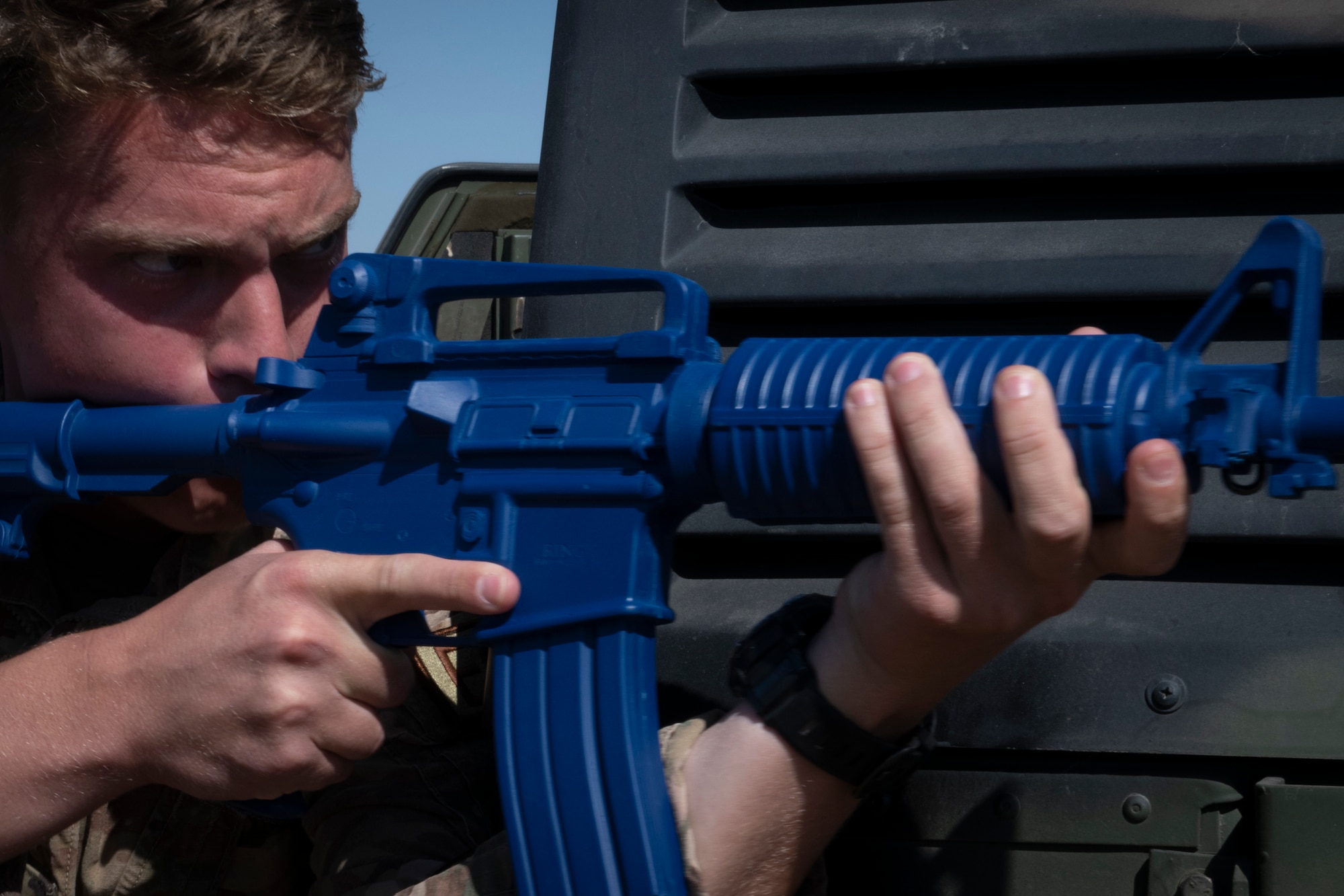 Airman holding dummy weapon in training