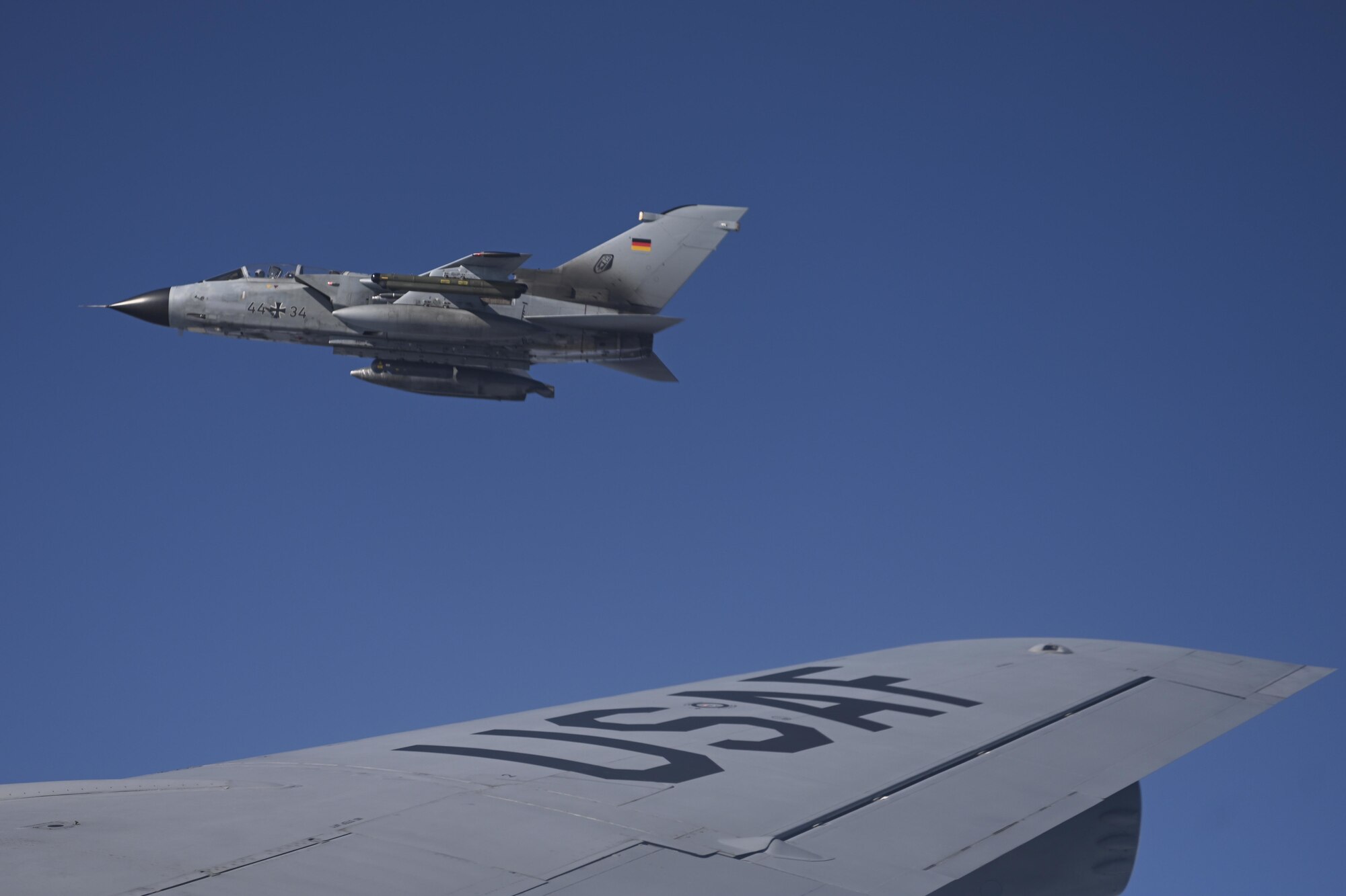 A German air force Tornado aircraft flies off the wing of a U.S. Air Force KC-135 Stratotanker aircraft assigned to the 100th Air Refueling Wing, Royal Air Force Mildenhall, England, after receiving fuel over Germany Aug. 2, 2021. The aerial refueling capabilities of the 100th ARW’s KC-135s extend the range of U.S., allied and partner-nation fighter aircraft. (U.S. Air Force photo by Senior Airman Joseph Barron)