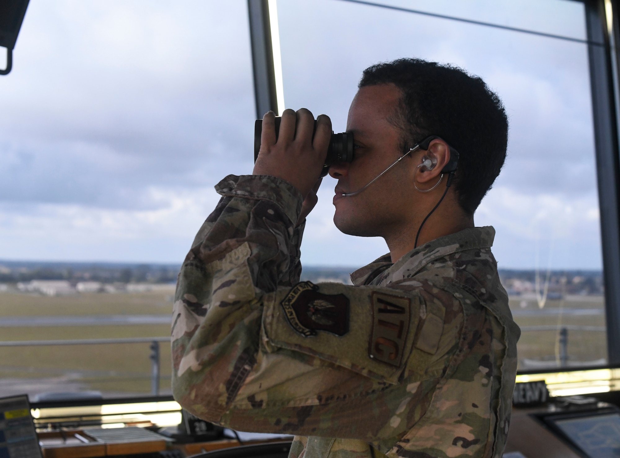 U.S. Senior Airman Malcolm Blair, 100th Operation Support Squadron air traffic controller, communicates with an incoming KC-135 Stratotanker aircraft July 28, 2021, at Royal Air Force Mildenhall, England. Aircrews and air traffic controllers are in constant communication within an estimated five miles of airspace. (U.S. Air Force photo by Senior Airman Antonia Herrera)