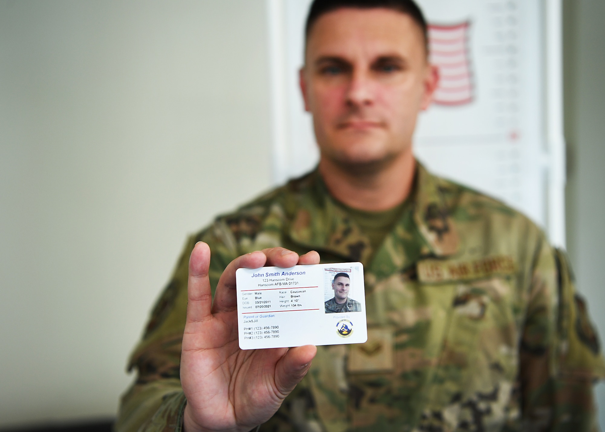 Airman holding ID card