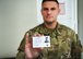 Senior Airman Christopher Anderson, 66th Security Forces Squadron Pass and Registration controller, holds a sample EZ Child ID card at Hanscom Air Force Base, Mass., July 21. The EZ Child ID can be used to assist law enforcement in the case of a missing person, and can be issued to children, teens, adults, or senior citizens. (U.S. Air Force photo by Lauren Russell)
