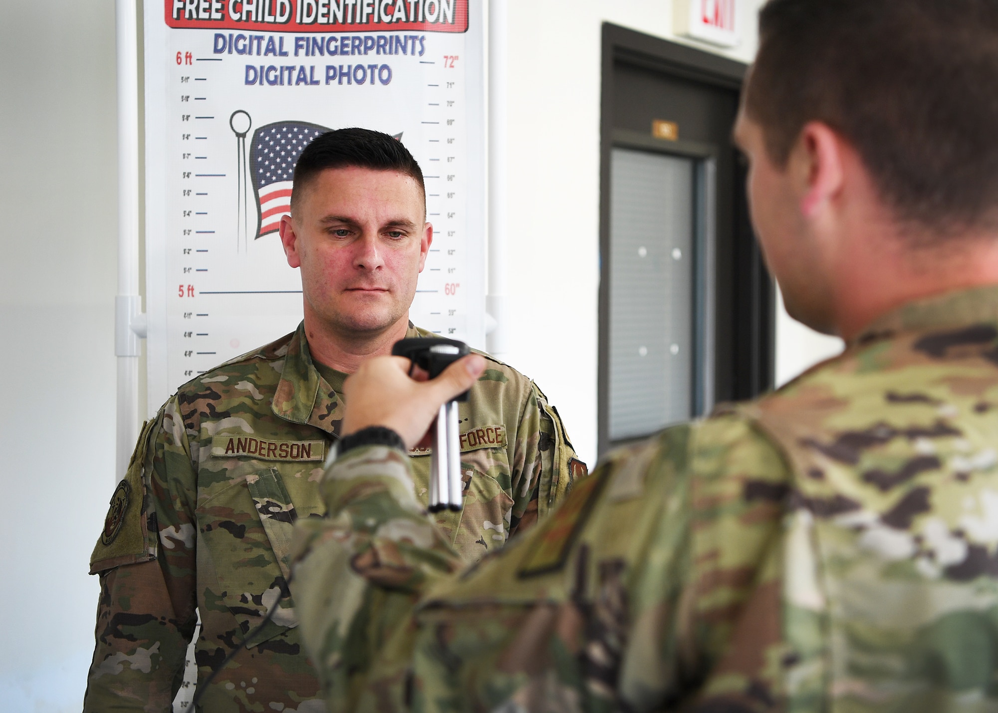 Two Airmen using identification device