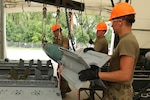 Airmen compete in the annual Ammo Rodeo, a two-week munitions training competition at Volk Field in Wisconsin July 28, 2021. About 50 U.S. Air Force Guard and Reserve members from units all over the country spent a week doing classroom work before competing in the bomb-building event.