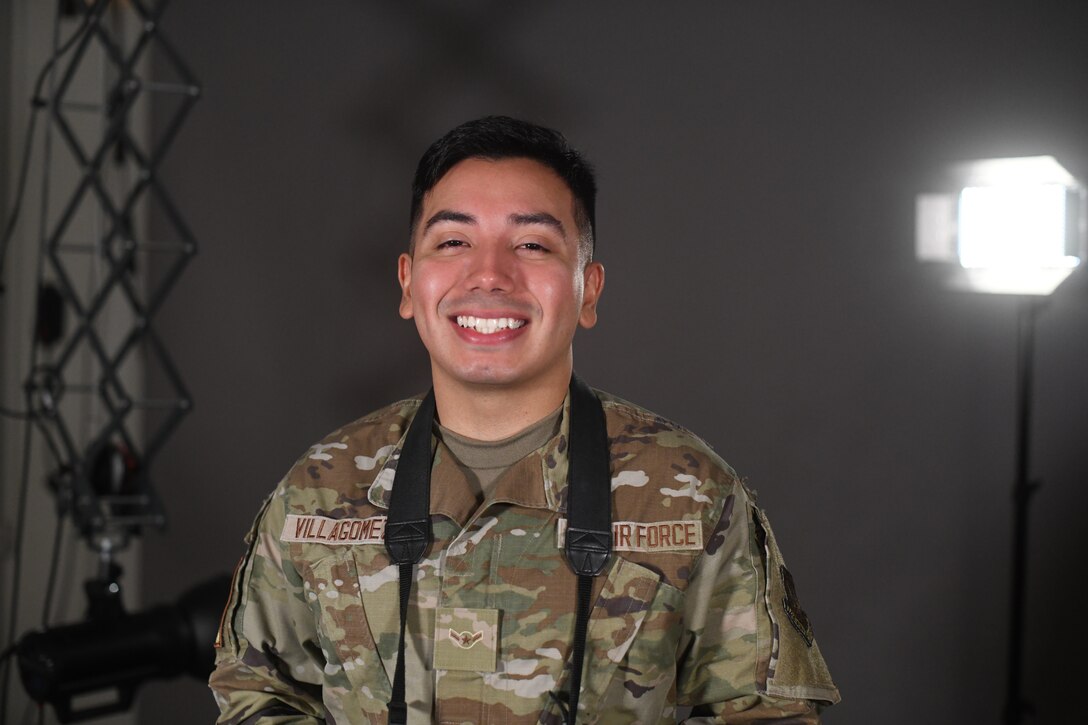 U.S. Air Force Airman Alvaro Villagomez, 100th Air Refueling Wing Public Affairs apprentice, poses in the studio with his camera July 28th, 2021, at Royal Air Force Mildenhall, England. Villagomez joined the Air Force to give himself a better life than his parents had when they immigrated from Mexico. (U.S. Air Force photo by Senior Airman Antonia Herrera)