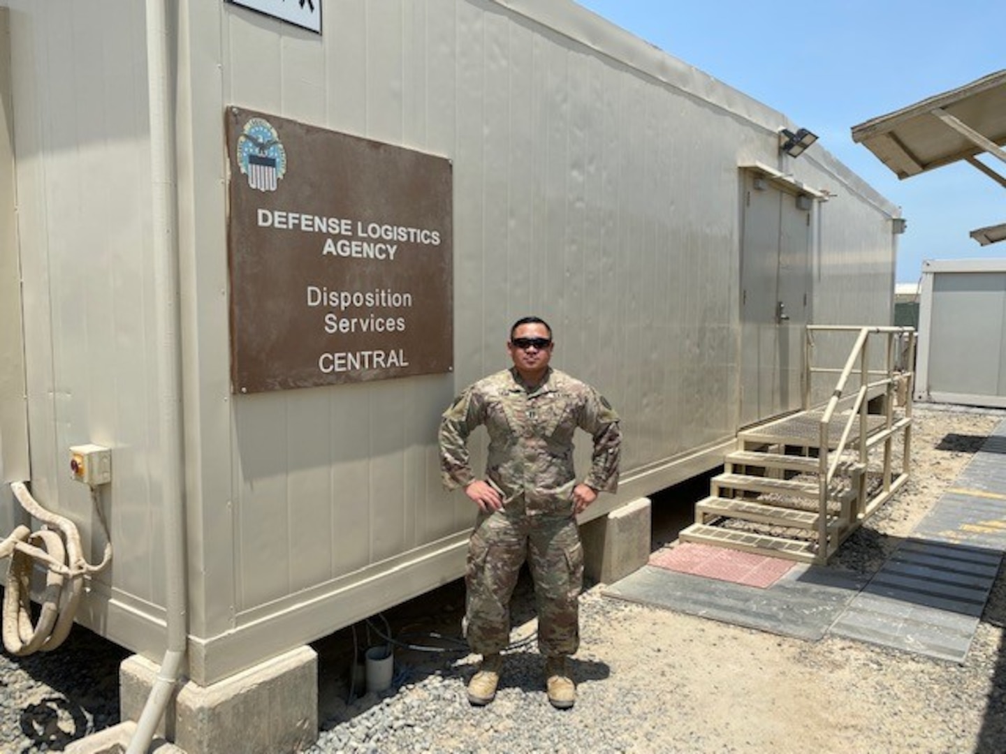 Man stands by DLA sign