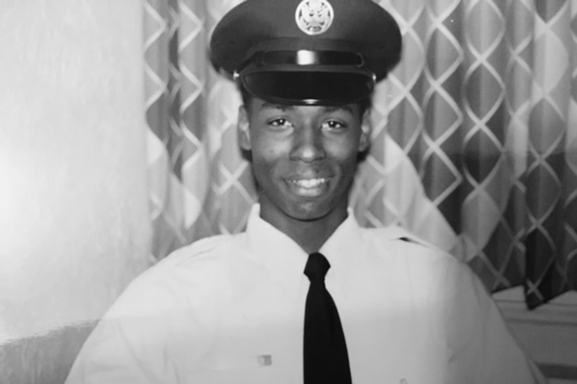 An airman smiles at the camera.