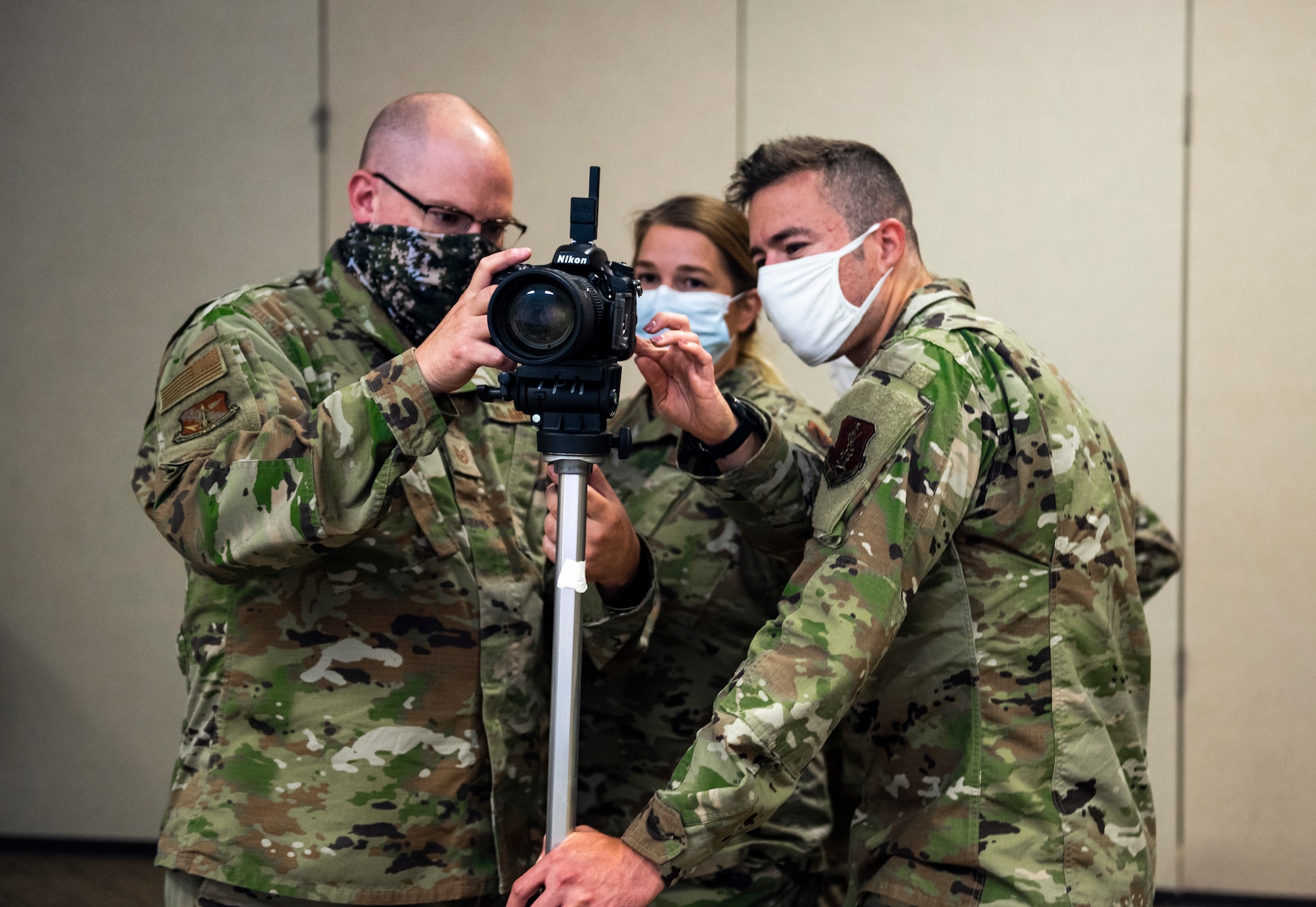 U.S. Air Force public affairs specialists from the 110th Wing, Michigan Air National Guard, and the 182nd Airlift Wing, Illinois Air National Guard, gather around for studio camera technique training during Northern Strike 21-2 at Alpena Combat Readiness Training Center, Michigan., Aug. 2, 2021. Northern Strike is one of the Department of Defense’s largest reserve component readiness exercises, which occurs for two weeks in the beginning of August at the National All-Domain Warfighting Center in Northern Michigan. (U.S. Air National Guard photo by Senior Airman Wynndermere Shaw)