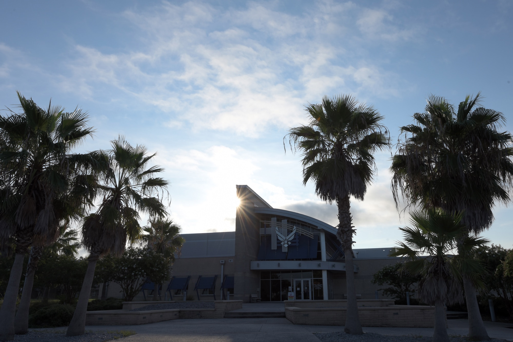 The sun rises behind the Fitness Center