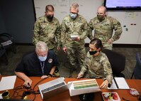 JOINT BASE LANGLEY-EUSTIS, Va. (Aug. 5, 2021) A Joint Task Force Civil Support (JTF-CS) operational planning team determines task organization for units assigned to notional hurricane response operations in a simulated joint operational area during exercise Vibrant Response 21.2.