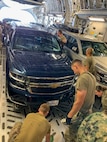 LANGLEY AIR FORCE BASE, Va. (Aug. 4, 2021) Joint Task Force Civil Support (JTF-CS) forward command element and incident support team members secure vehicles inside the fuselage of a C-17 Globemaster III en route to Tennessee during exercise Vibrant Response 21.2.