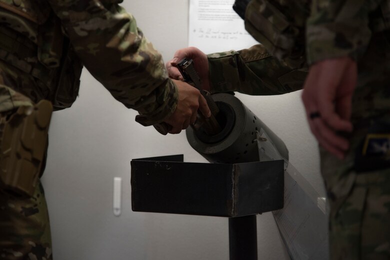 U.S. Air Force Col. David Wilson, 21st Mission Support Group commander, clears his issued M-18 pistol before leaving the 21st Security Forces Squadron headquarters for duty at Peterson Space Force Base, Colorado, July 22, 2021. (U.S. Space Force photo by Airman Aaron Edwards)