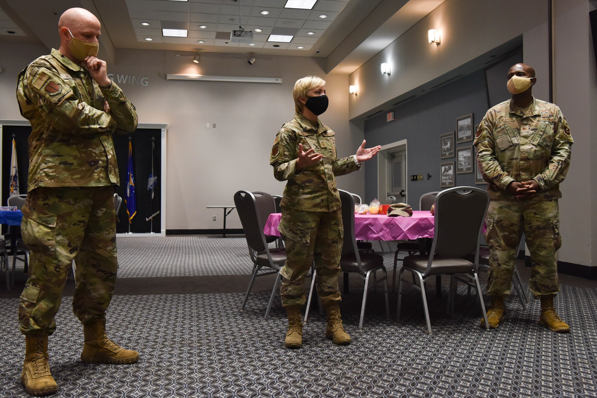 U.S. Air Force Chief Master Sgt. Casy Boomershine, 17th Training Wing command chief speaks at the Care for the Caregivers event, while Col. Matthew Reilman, 17th TRW commander, and Col. James Finlayson, 17th TRW vice commander observe on Goodfellow Air Force Base, Texas, Aug. 5, 2021. The event was dedicated to the caregivers of Goodfellow for all their hard work over the past year in providing mental, physical, social, and spiritual care for the base. (U.S. Air Force photo by Senior Airman Jermaine Ayers)