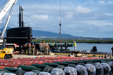 JOINT BASE PEARL HARBOR-HICKAM (July 28, 2021) -- Sailors assigned to the Los Angeles-class fast-attack submarine USS Chicago (SSN 721), along with civilian contractors with BAE Systems, load a UGM-84 anti-ship harpoon missile onto the submarine in preparation of Large-Scale Exercise (LSE) 2021. LSE 2021 is a live, virtual, and constructive, scenario-driven, globally integrated exercise that will provide high-end training at sea and ashore. (U.S. Navy photo by Mass Communication Specialist 1st Class Michael B. Zingaro/Released)
