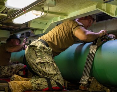 JOINT BASE PEARL HARBOR-HICKAM (July 28, 2021) -- Sailors assigned to the Los Angeles-class fast-attack submarine USS Chicago (SSN 721) secure a UGM-84 anti-ship harpoon missile onto the submarine in preparation of Large-Scale Exercise (LSE) 2021. LSE 2021 is a live, virtual, and constructive, scenario-driven, globally integrated exercise that will provide high-end training at sea and ashore.(U.S. Navy photo by Mass Communication Specialist 2nd Class Greg Hall/ Released)