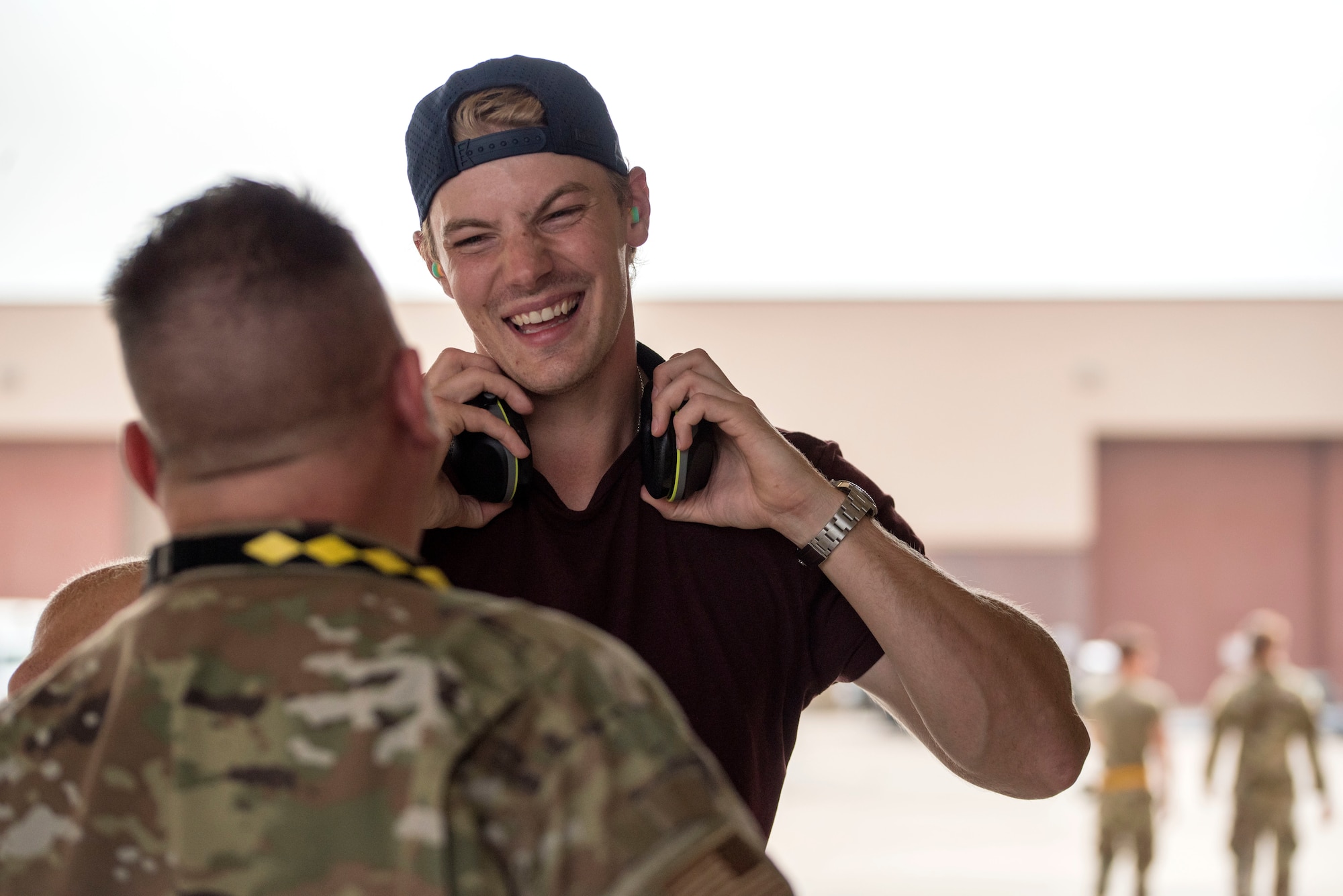 Scott Mayfield, NHL New York Islanders hockey player, speaks with Chief Master Sgt. Christopher Dixon, 849th Aircraft Maintenance Squadron superintendent, after watching an F-16 Viper taxi down the runway, Aug. 3, 2021, on Holloman Air Force Base, New Mexico. Mayfield had the opportunity to fly in a familiarization flight with his brother, Capt. Patrick Mayfield, 314th Fighter Squadron instructor pilot. (U.S. Air Force photo by Staff Sgt. Christine Groening)