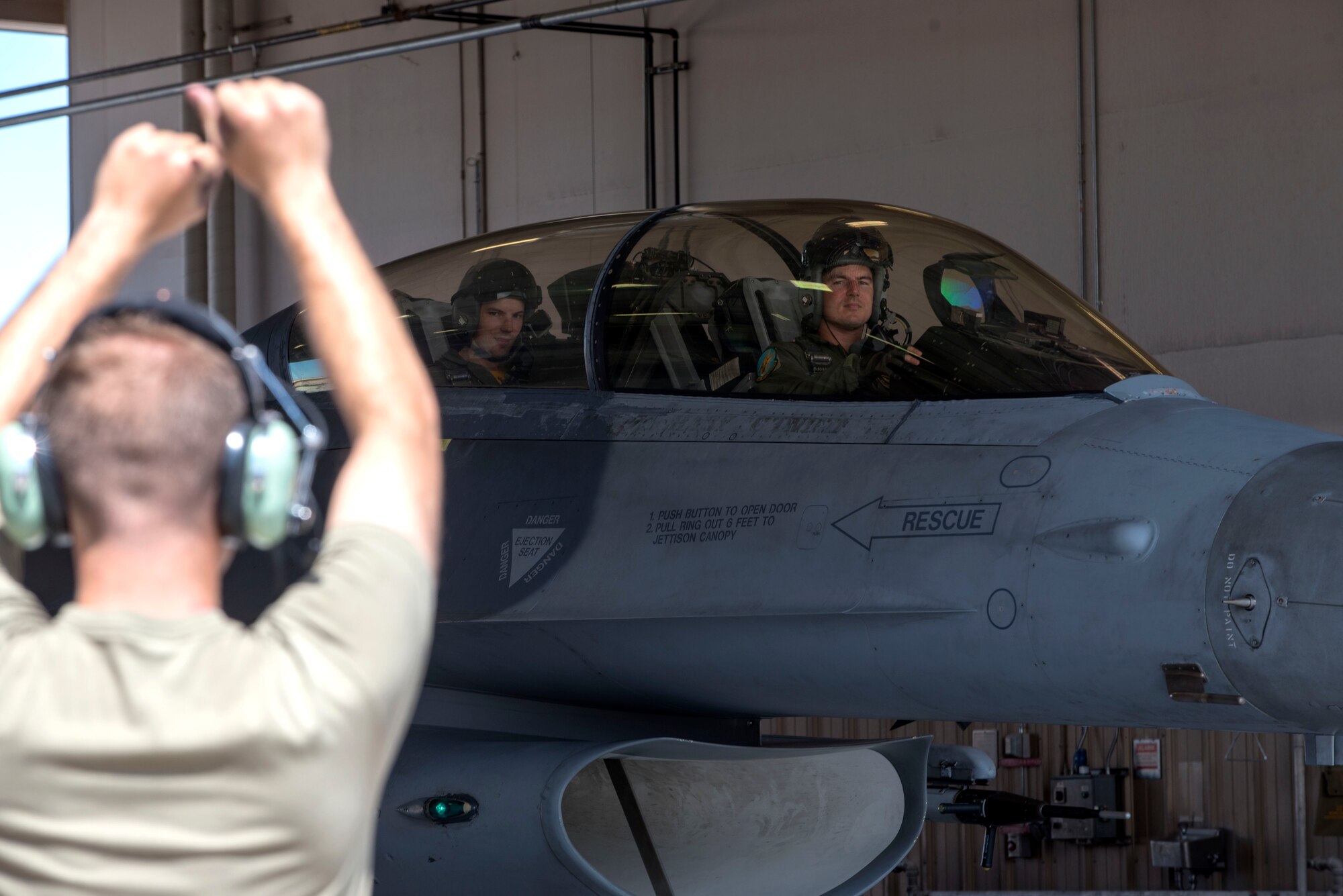 Capt. Patrick Mayfield, 314th Fighter Squadron instructor pilot, and Scott Mayfield, NHL New York Islanders hockey player, taxi into a hanger after a familiarization flight, Aug. 4, 2021, on Holloman Air Force Base. In addition to the flight, Scott toured the Optimizing the Human Weapon System facility, received aircrew flight equipment egress and parachute training, and visited maintainers on the flight line to understand the correlation of teamwork and training between the NHL and the U.S. Air Force. (U.S. Air Force photo by Staff Sgt. Christine Groening)