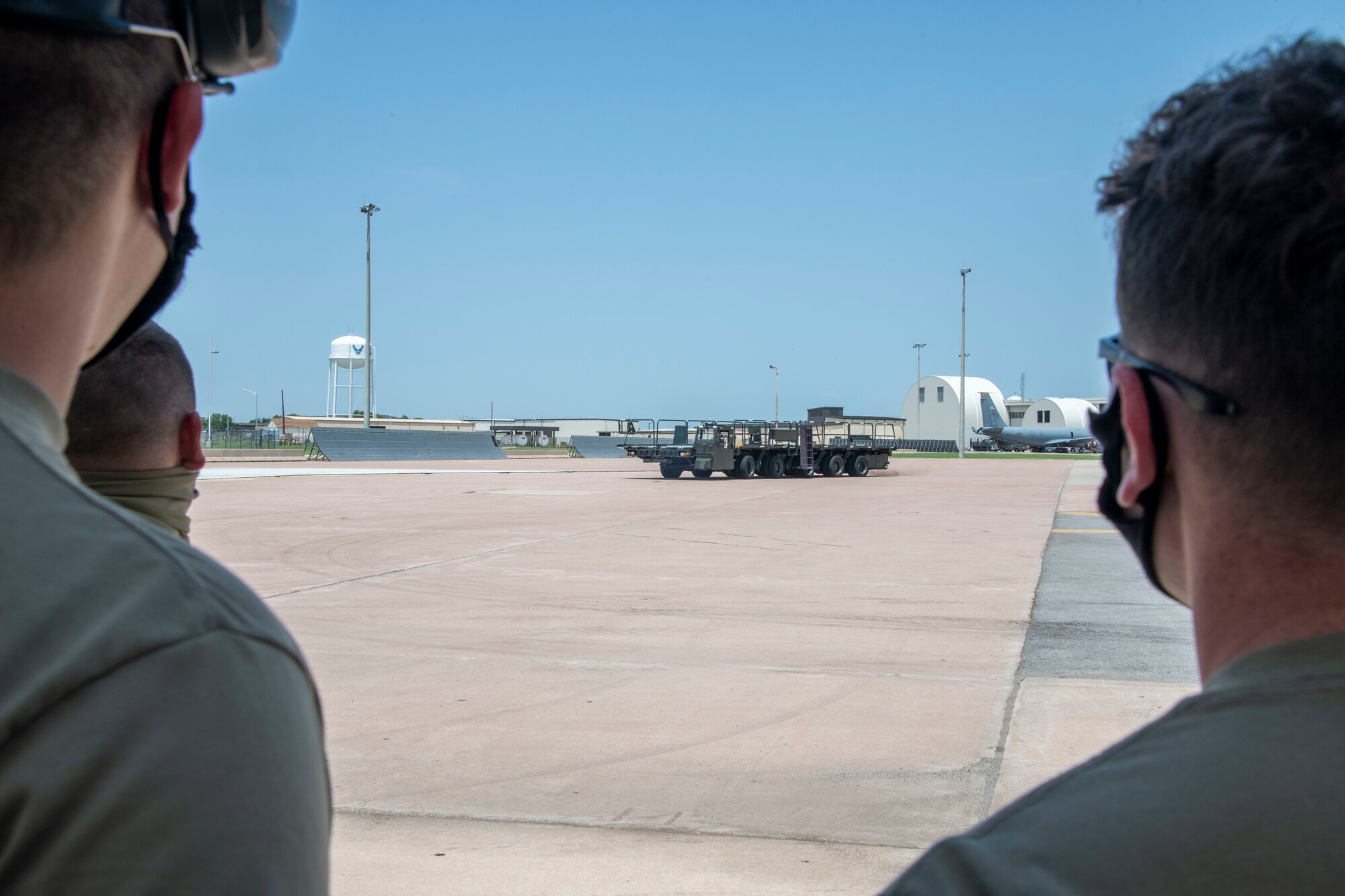 190th Logistics Readiness Squadron (LRS) Airmen watch as one of their members operates a Tunner 60K Aircraft Cargo Loader/Transporter at Altus Air Force Base, Oklahoma, July 27, 2021.