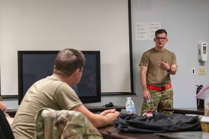 U.S. Air Force Staff Sgt. Spencer Lanston, 97th Logistics Readiness Squadron air freight supervisor, gives an over brief of the training day at Altus Air Force Base, Oklahoma, July 27, 2021.