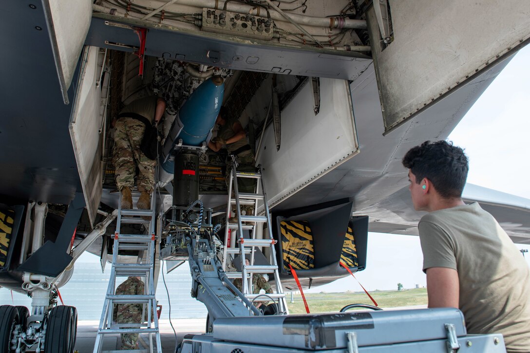 Military members load explosives