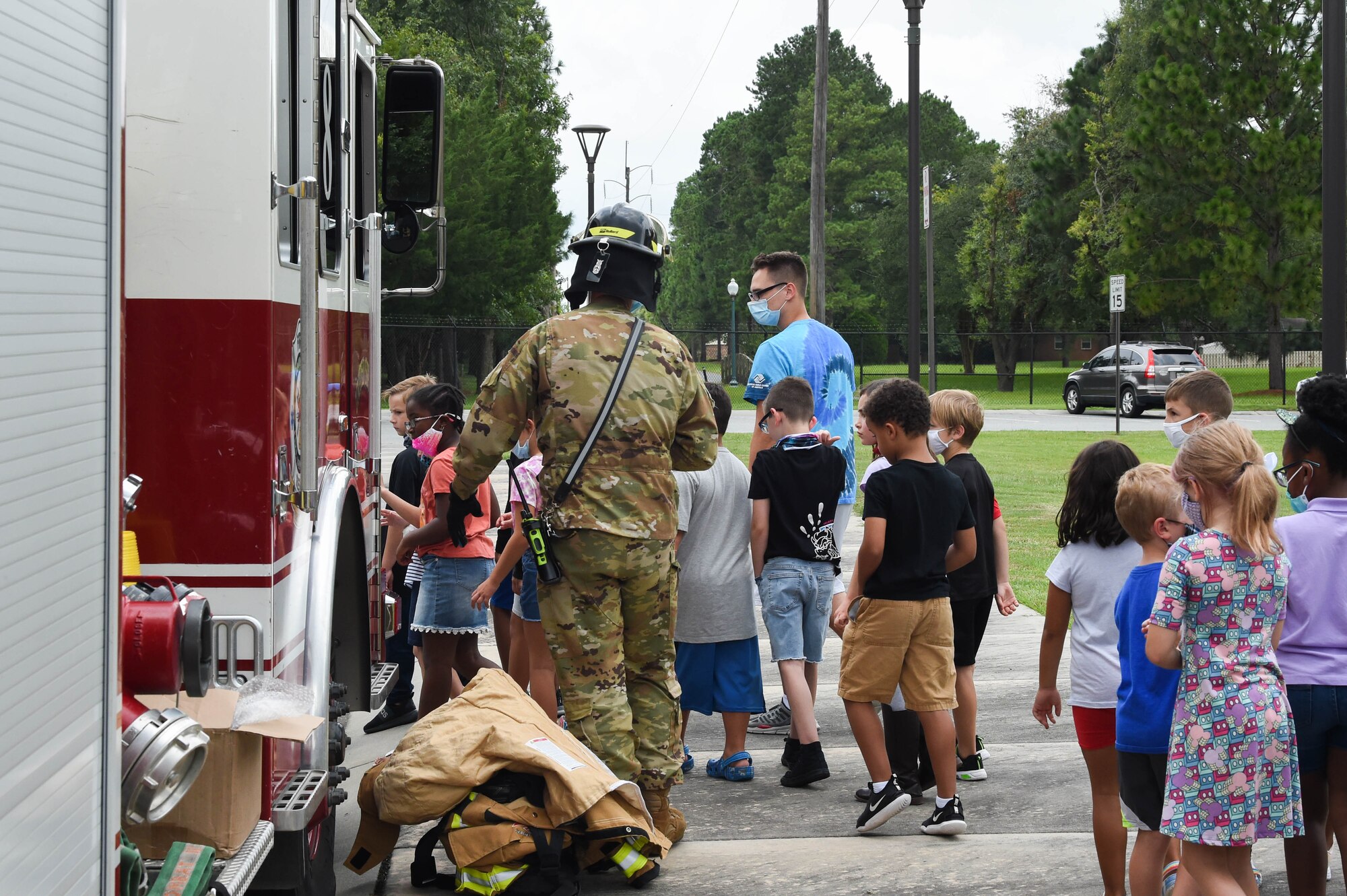 Children follow U.S. Air Force Airman 1st Class Dorian Flagg, 23rd Civil Engineer Squadron fire fighter, to ask questions and look inside a firetruck during an education day with Lowndes County Sheriff’s Office, 23rd Security Forces Squadron and 23rd CES fire department at Moody Air Force Base, Georgia, Aug. 3, 2021. Flagg educated the children on the capabilities of the firetruck. (U.S. Air Force photo by Senior Airman Rebeckah Medeiros)