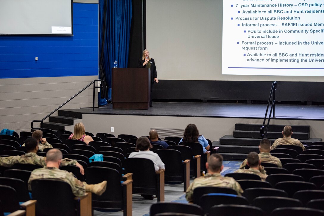 Woman speaks to crowd.