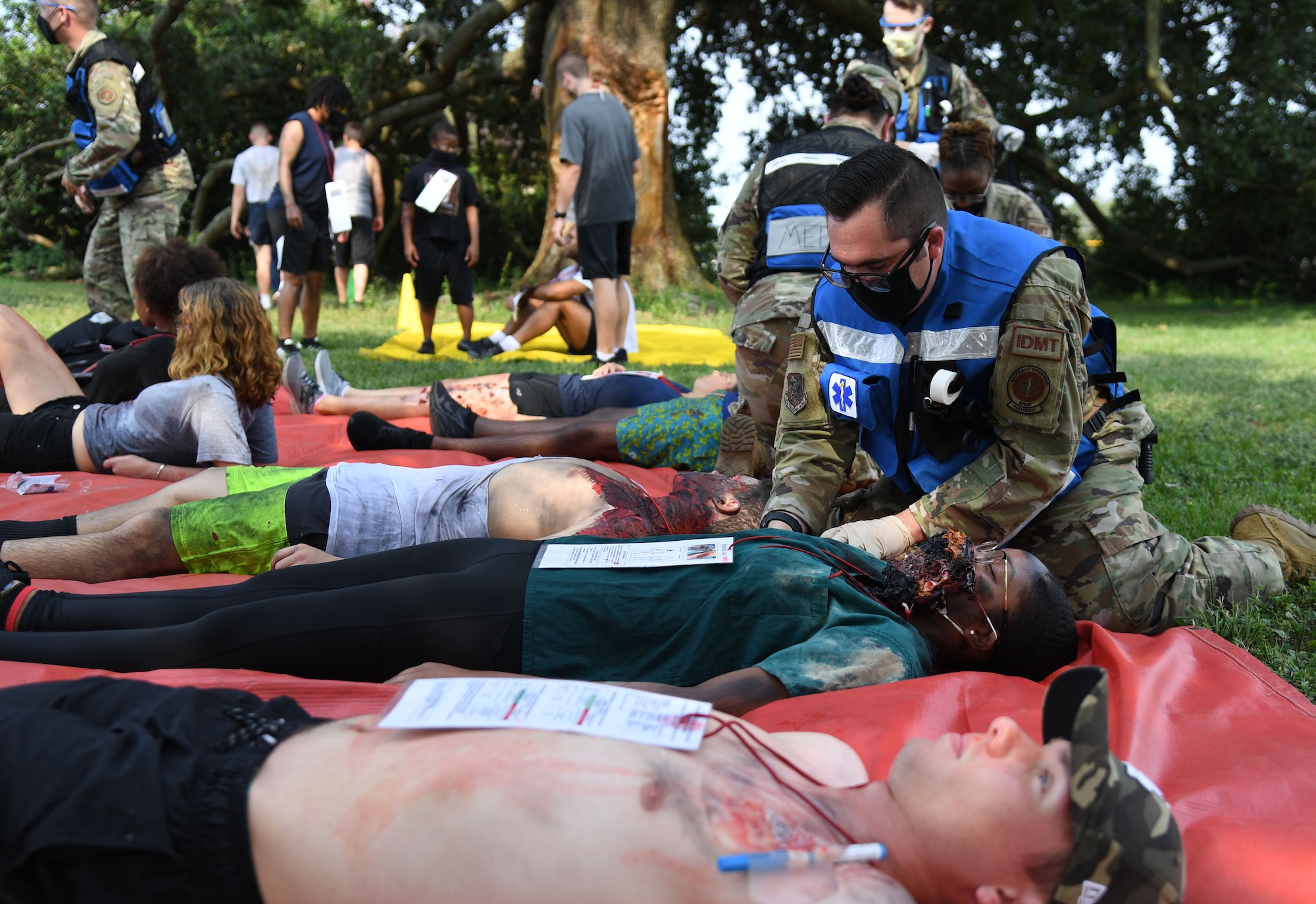 Keesler first responders medically assess actors portraying victims during a Chemical, Biological, Radiological, Nuclear exercise at Keesler Air Force Base, Mississippi, Aug. 6, 2021. The Ready Eagle exercise tested the base's ability to respond to and recover from a mass casualty event. (U.S. Air Force photo by Kemberly Groue)