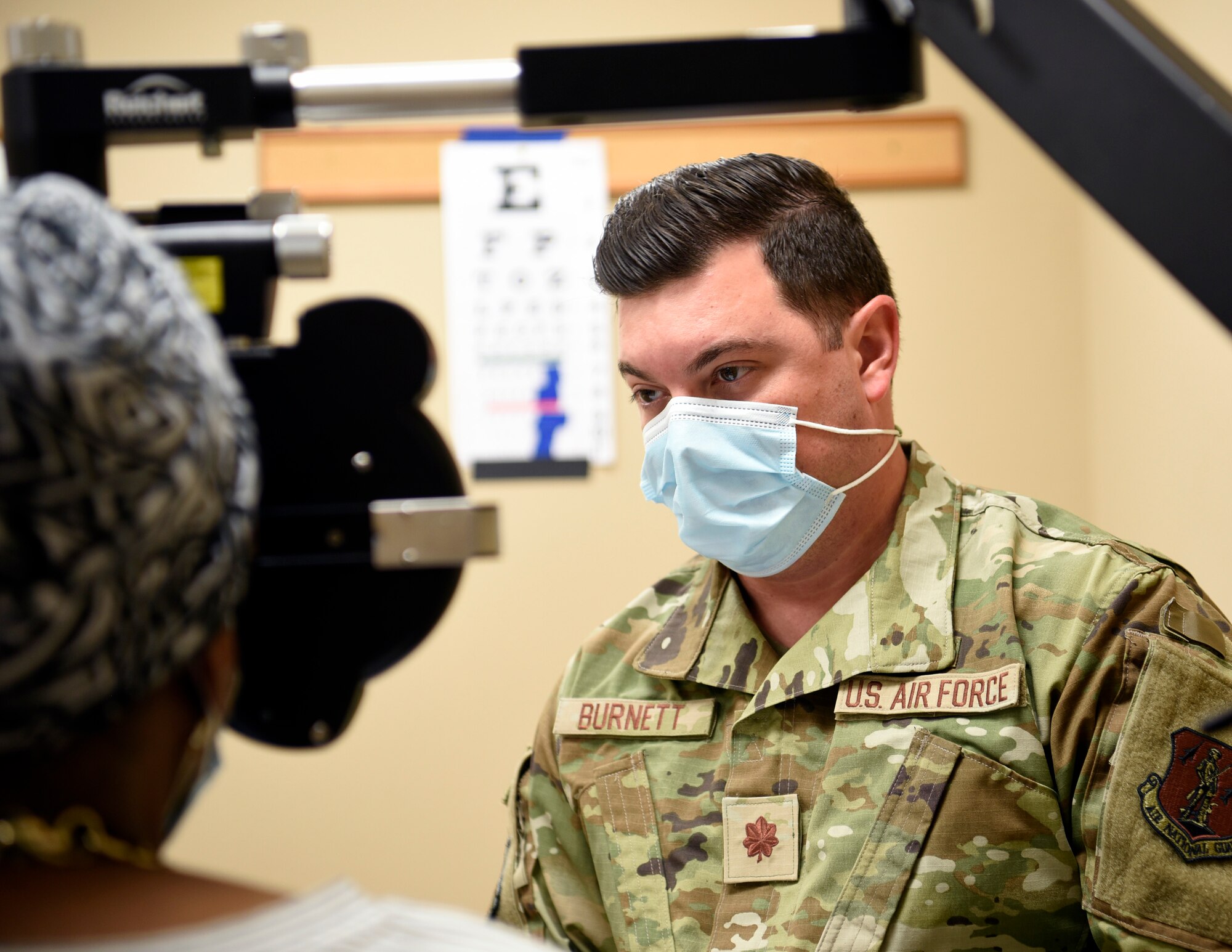 U.S. Air Force Capt. Erik Burnett, an optometrist assigned to the 162nd Medical Group, Morris ANGB, Tucson, Arizona, performs an eye exam on a patient at the Operation Healthy Delta clinic site in Sikeston, Missouri, June 21. The operation is a U.S. Department of Defense Innovative Readiness Training mission, offering readiness training to multi-service, interagency, and community partners, while providing no-cost healthcare to the community. (U.S. Air National Guard Photo by Technical Sgt. Rafael Medina/Released)