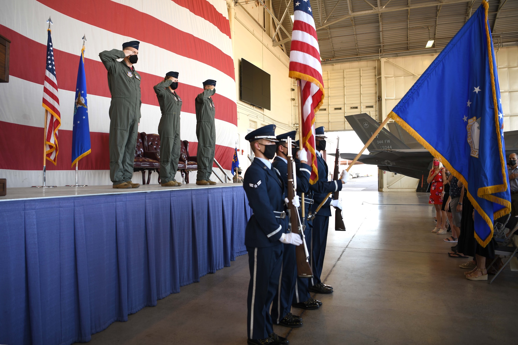 LUKE AIR FORCE BASE, ARIZ. – Honor guardsmen from the 56th Fighter Wing presents the colors during the 944th Operations Group change of command ceremony, August 6, 2021, at Luke Air Force Base, Arizona. In front of family, friends, and Airmen, Col. Mark Van Brunt, 944th Fighter Wing commander, relieved Reserve Citizen Airman Col. Trena Savageau, 944th OG commander of command and presented it to Col. Brett Comer, incoming commander. (U.S. Air Force Photo/Tech. Sgt. Courtney Richardson)