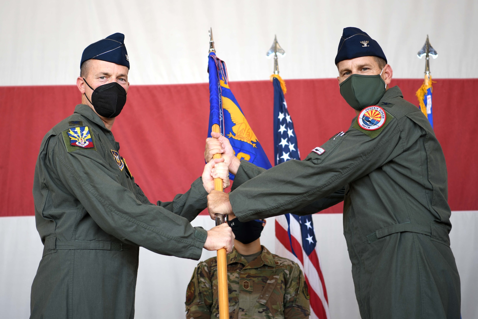 LUKE AIR FORCE BASE, ARIZ. – Reserve Citizen Airman Col. Mark Van Brunt, 944th Fighter Wing commander, presents Col. Brett Comer command of the 944th Operations Group during a change of command ceremony, August 6, 2021 at Luke Air Force Base, Arizona. Comer was the previous commander of the 301st Operations Support Squadron, 301st Fighter Wing, at Nellis Air Force Base, Neveda. (U.S. Air Force Photo/Tech. Sgt. Courtney Richardson)