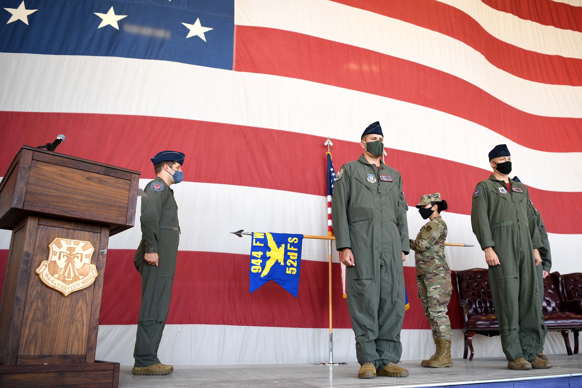LUKE AIR FORCE BASE, ARIZ. – Reserve Citizen Airman Senior Master Sgt. Jacqueline Flores, 944th Operations Group Superintendent, unveils the new flag for the 52nd Fighter Squadron at the reactivation ceremony at Luke Air Force Base, Arizona, August 6, 2021. Detachment 2 grew in personnel changing their designation to a fighter squadron. They are still recognized as the Ninjas. (U.S. Air Force Photo/Tech. Sgt. Courtney Richardson)