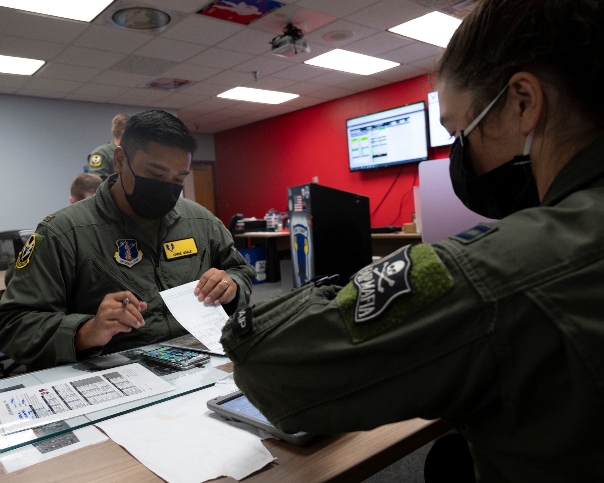 U.S. Air Force 2nd Lt. Christopher Ugale, a student pilot with the 47th Student Squadron, goes over the pre-flight brief with U.S. Air Force Capt. Sarah Fotsch at Laughlin Air Force Base, Texas on August 4, 2021. The pre-flight brief covers the plan for the flight as well as looking at bird levels, visibility, and other required information. (U.S. Air Force Photo by Senior Airman Nicholas Larsen)