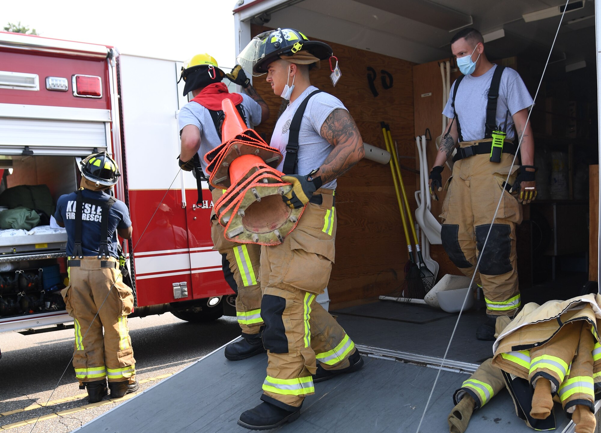 Members of the Keesler fire department gathers equipment to set up a decontamination site during a Chemical, Biological, Radiological, Nuclear exercise at Keesler Air Force Base, Mississippi, Aug. 6, 2021. The Ready Eagle exercise tested the base's ability to respond to and recover from a mass casualty event. (U.S. Air Force photo by Kemberly Groue)