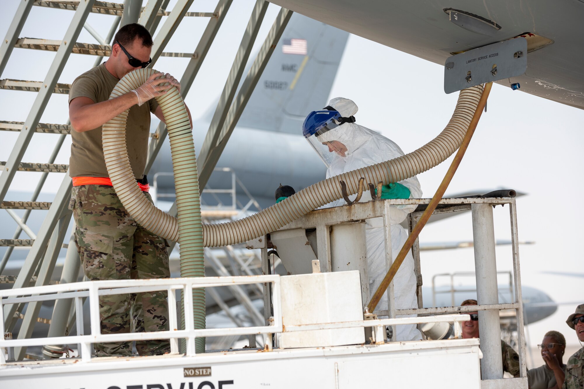 Female service member receives guidance during lavatory training