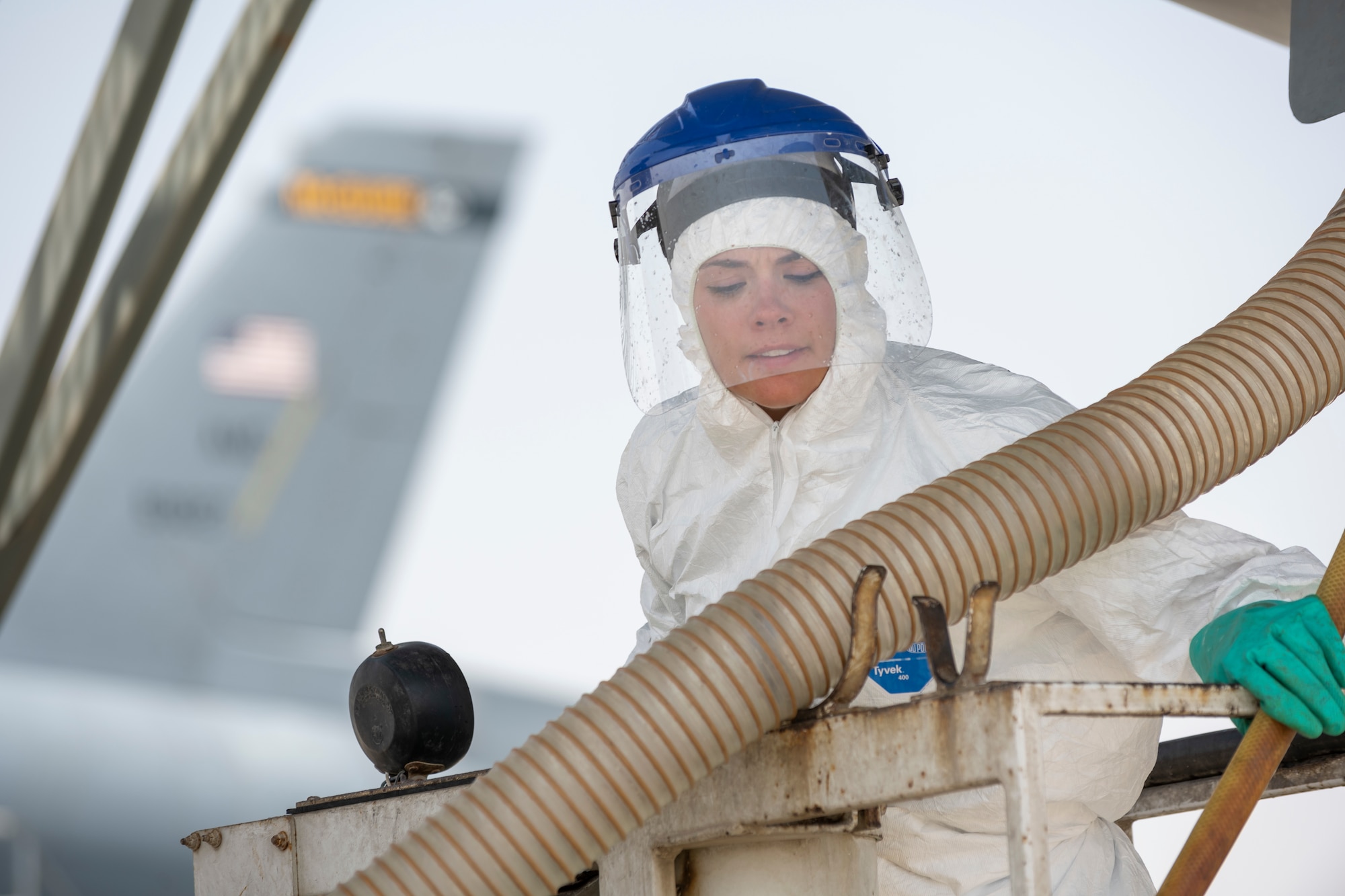 Female service member conducts lavatory servicing