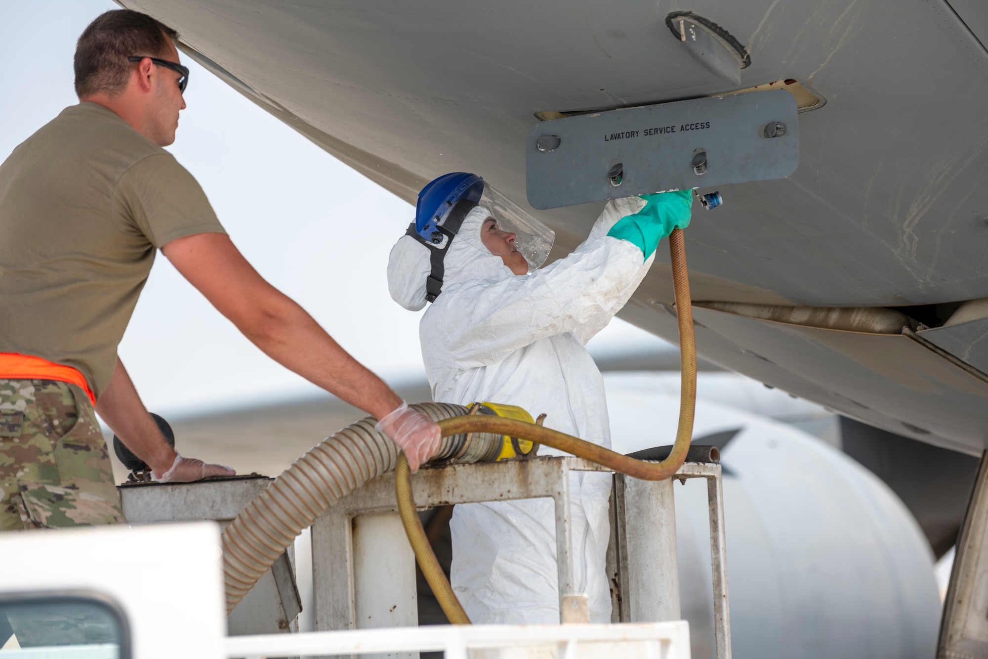 Female service member receives guidance during lavatory training